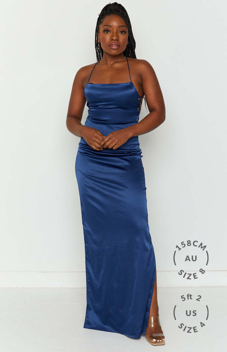 Navy satin maxi dress with cowl neck, thin straps, ruched side detail, and high leg split