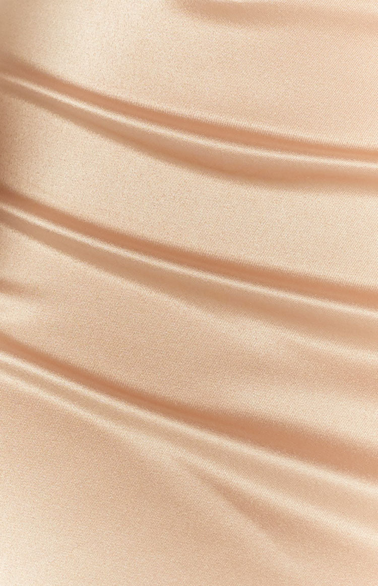 Close-up of the champagne satin fabric of the dress, showing its smooth texture and gentle folds