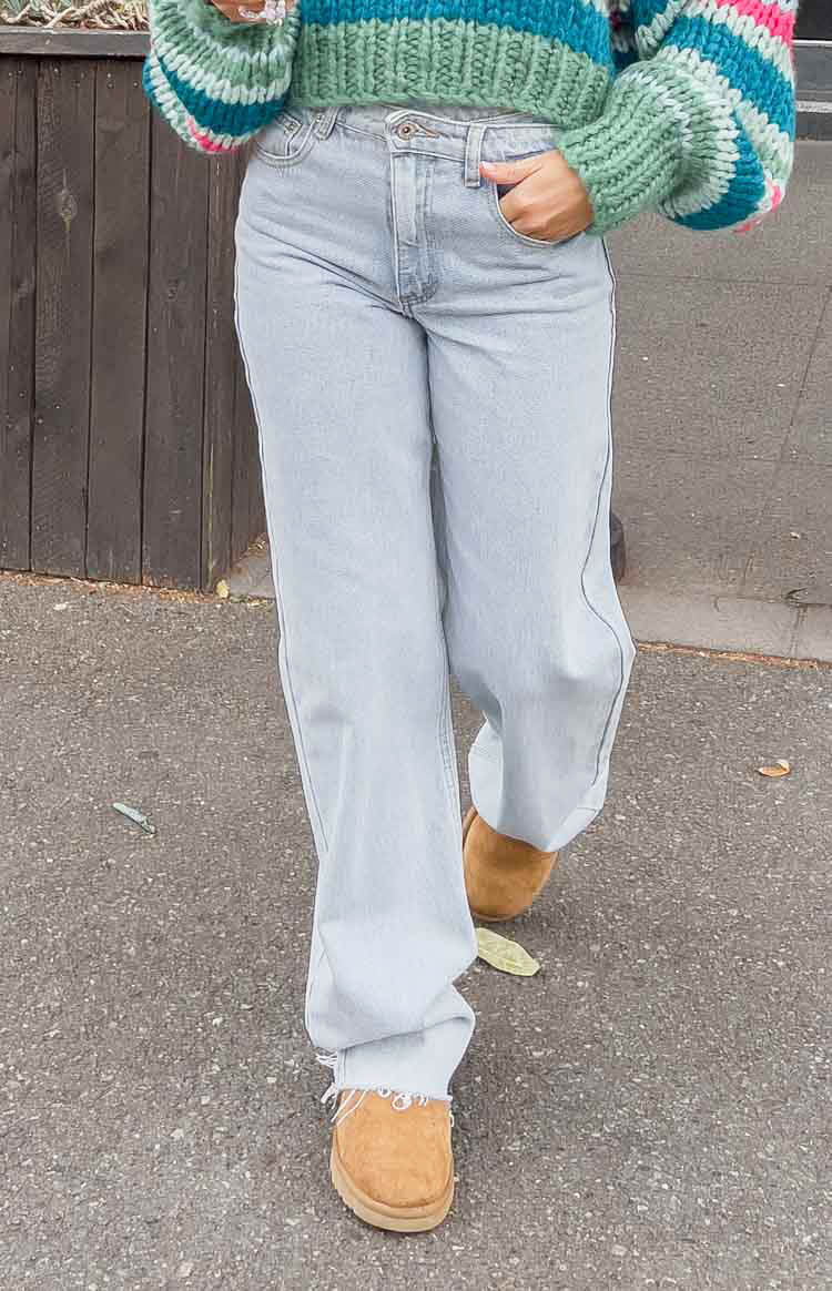 Front view of light blue wide-leg jeans with a relaxed fit and frayed raw hem