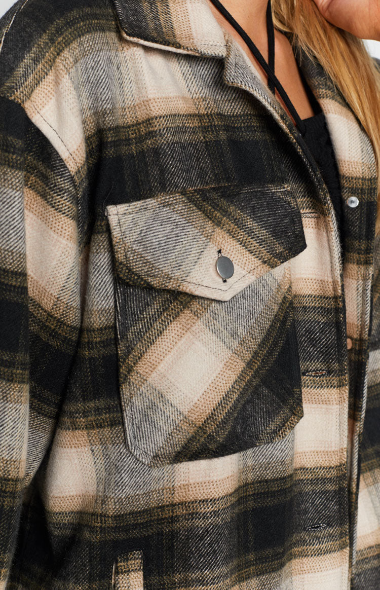 Black, beige, and brown check fleece jacket with a chest flap pocket and silver button