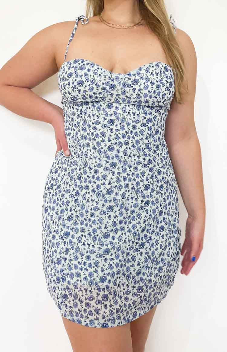 Light blue ditsy floral mini dress with sweetheart neckline, tie-shoulder straps, and shirred bodycon fit