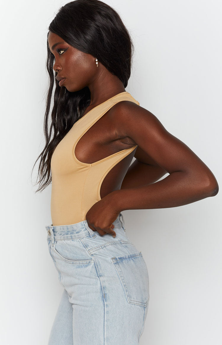 Fitted beige jersey bodysuit with a high neckline and wide, low-cut armholes
