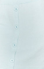 Soft light blue knit skirt fabric with a vertical row of four round matching buttons