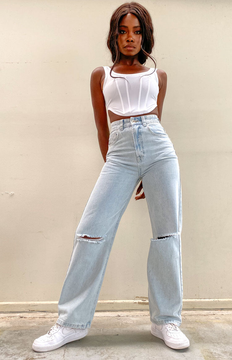 Light blue wash denim wide leg jeans with high waist and ripped knees