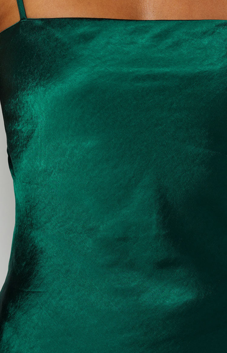 Teal party dress close up showing the shimmering, crinkled satin fabric and a delicate shoulder strap