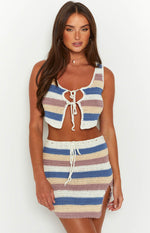 Fitted white, blue, and pink striped crochet mini skirt with a drawstring waist and side slit