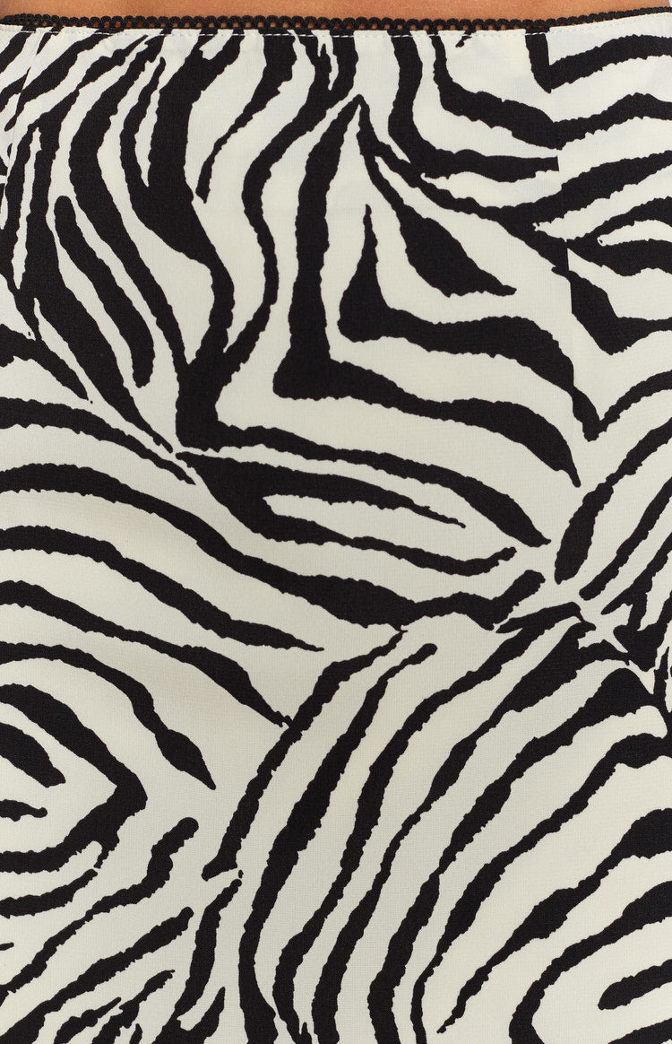 Black and white zebra print mini skirt, detailed view of the wavy stripes and a black picot trim waistband