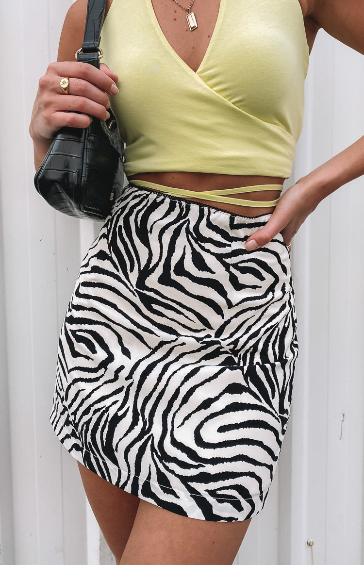 Black and white zebra print Saturn Mini Skirt, a high-waisted fitted style in smooth satin fabric