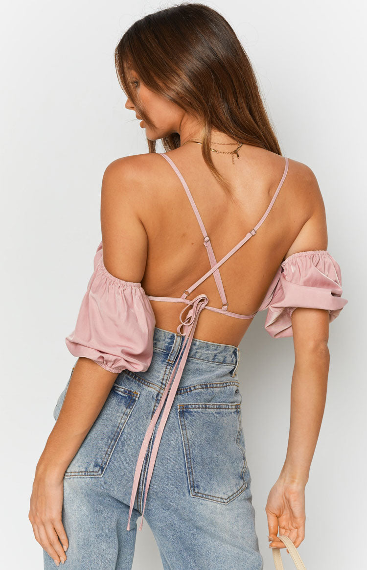 Pink crop top with off-shoulder puff sleeves, open back, and adjustable criss-cross spaghetti straps with tie closure