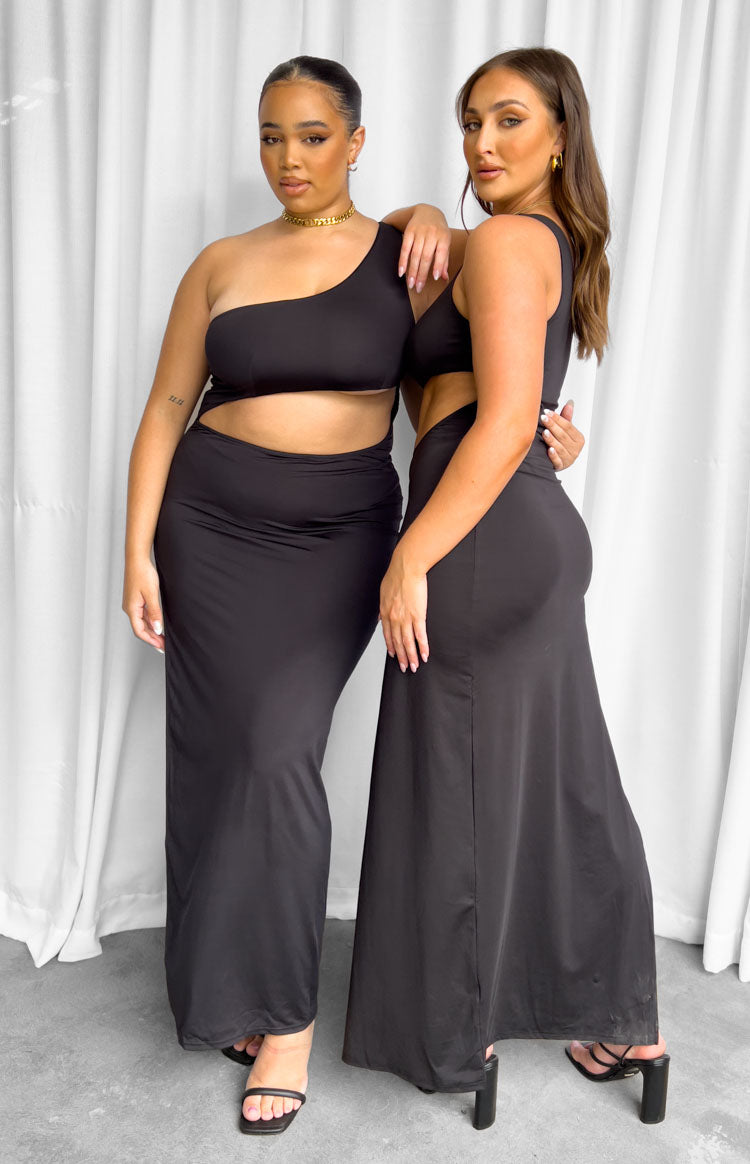 Black one-shoulder maxi dress with a midriff cut-out and a long, fitted silhouette