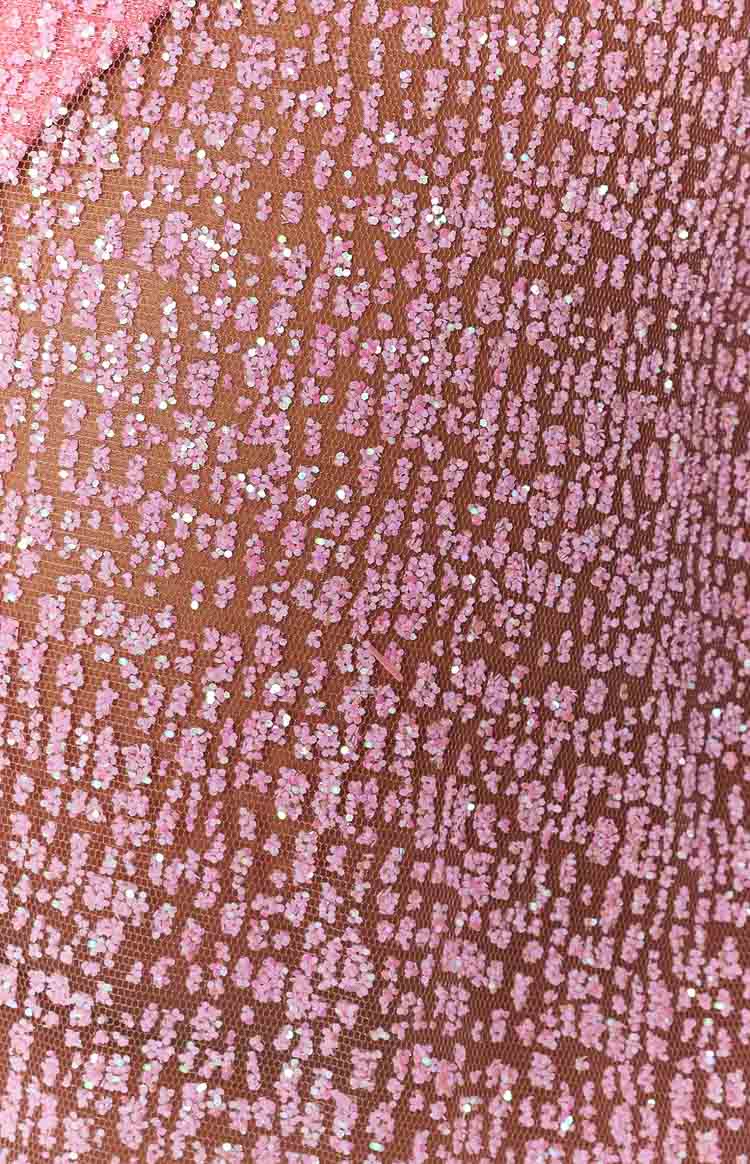 Close-up of the pink sparkle fabric, a sheer mesh with scattered glitter creating a subtle leopard pattern