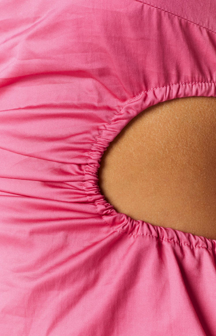 Close-up of the ruched circular cutout on a pink mini dress, showing the gathered fabric edges