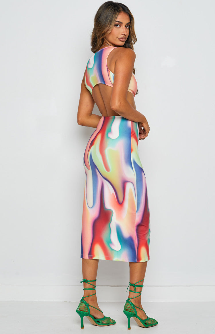 Side view of a multi-coloured abstract print midi dress with a cut-out back and fitted silhouette