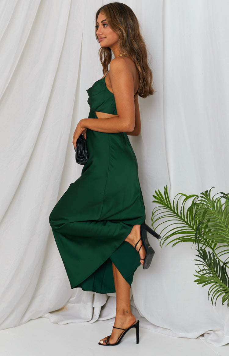 Emerald green satin maxi dress with a cowl neck, thin straps, side waist cutouts, and a high side split