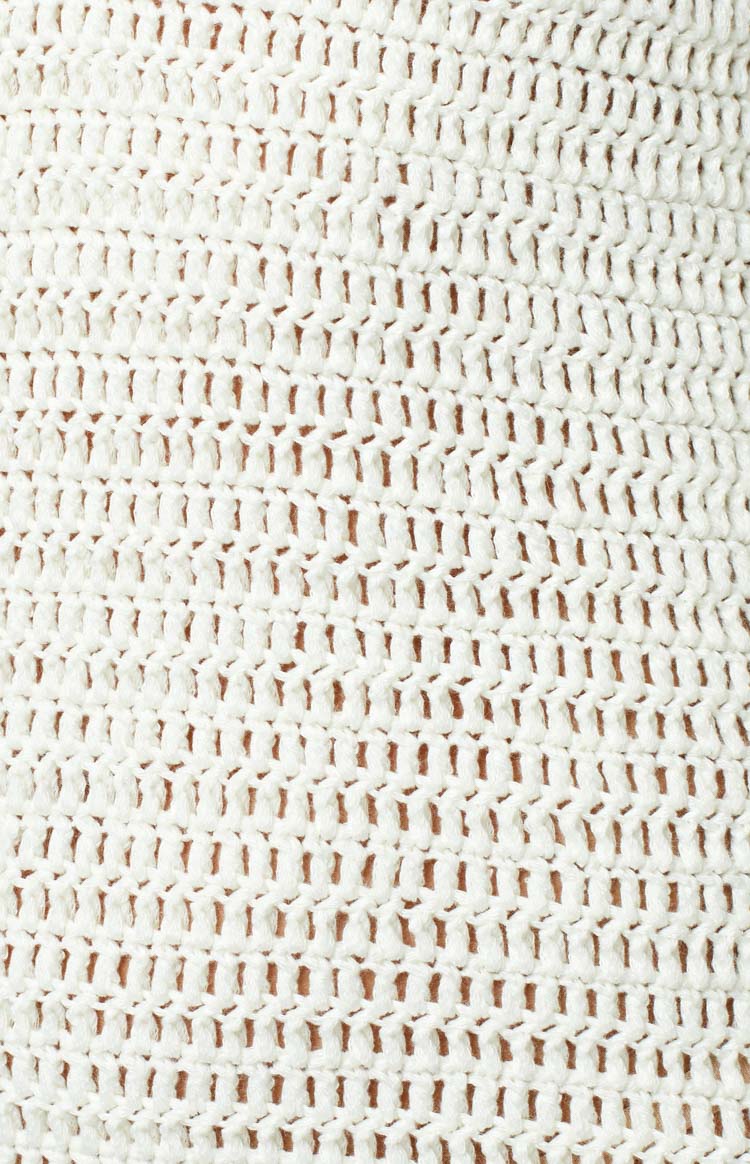 Close-up of the white open-knit crochet fabric showing its textured pattern