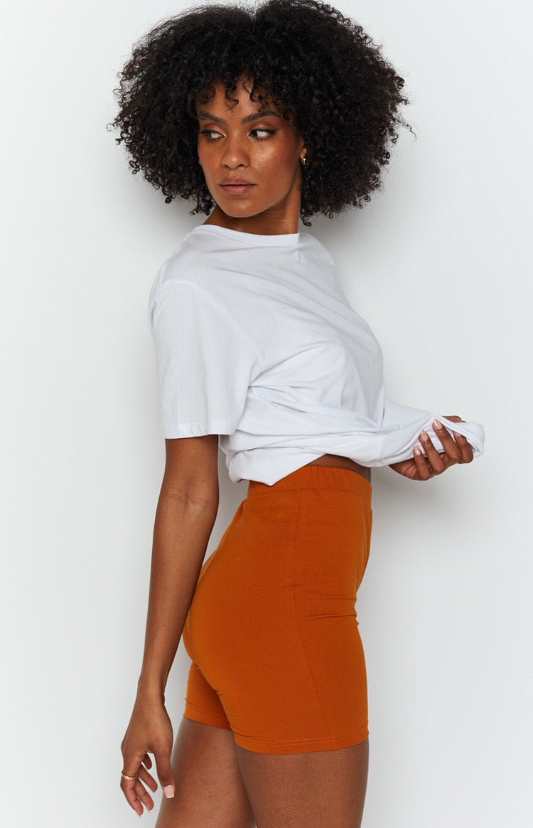 High-waisted tan fitted shorts in a smooth knit fabric