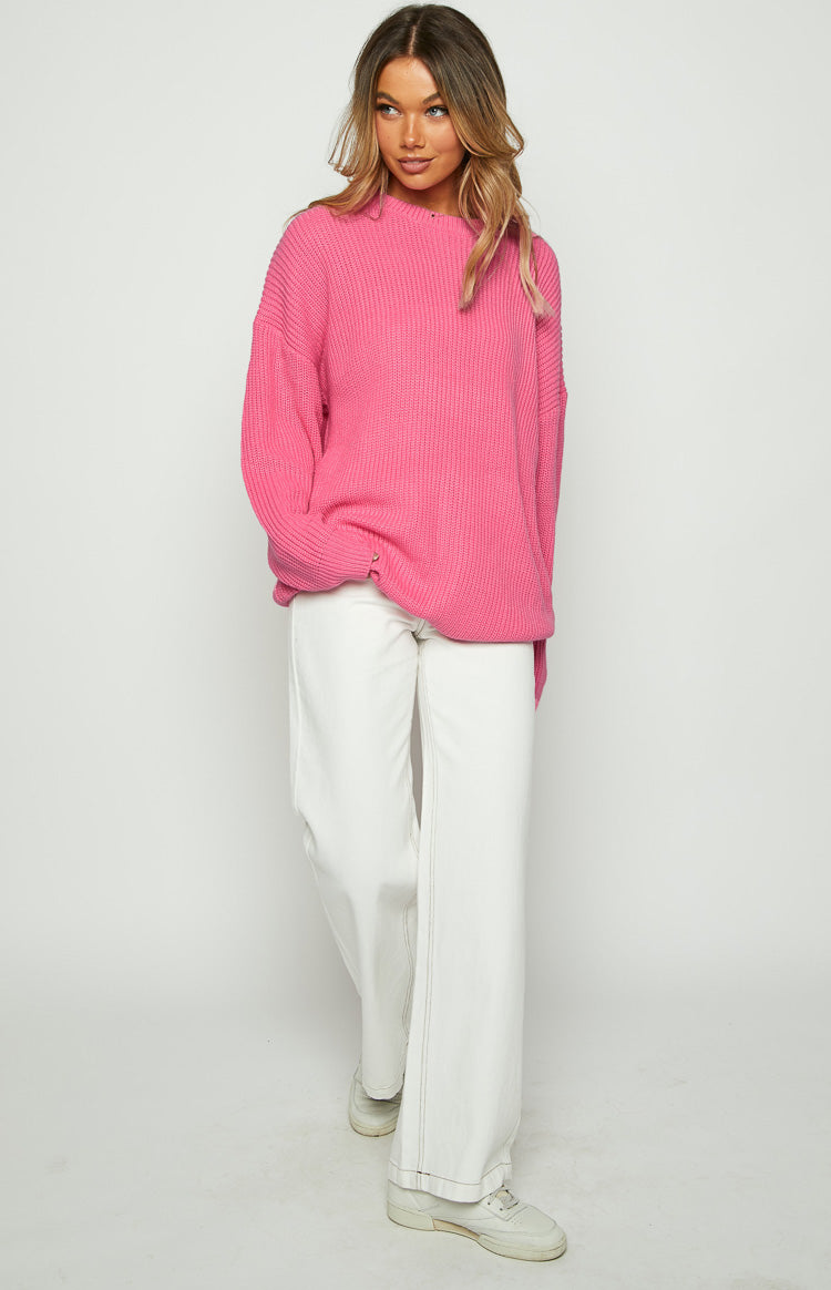Pink oversized sweater dress with a chunky ribbed knit texture and long sleeves