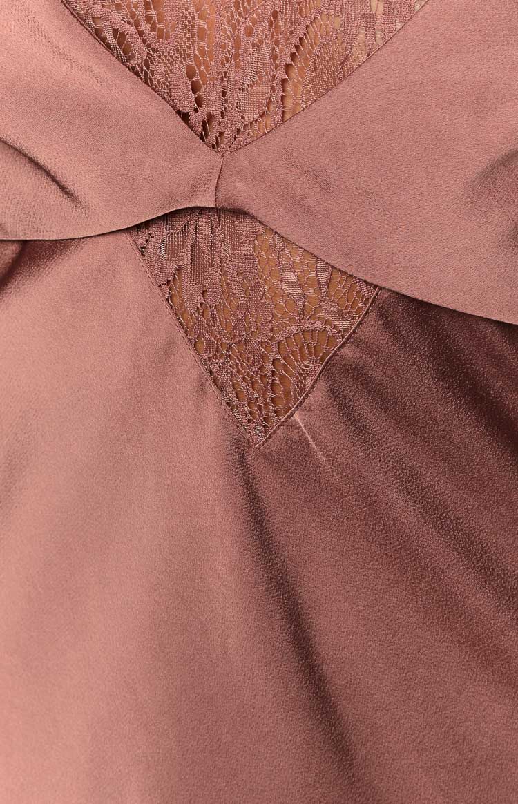 Close-up of the brown satin bust featuring a central knot detail and lace inserts
