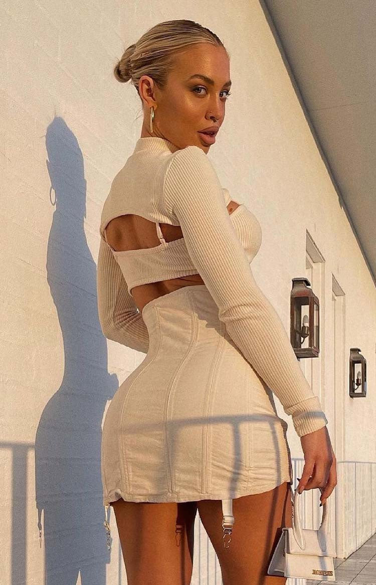 High neck cream ribbed knit long sleeve top with a large open back detail